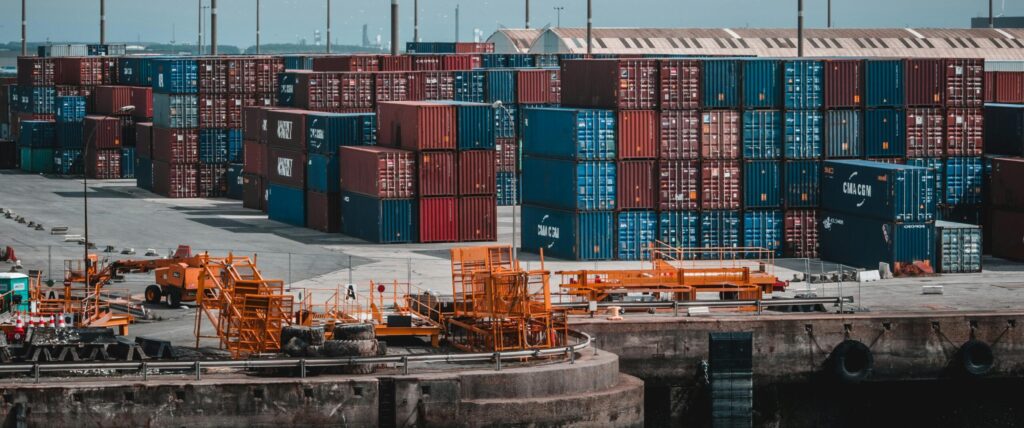 Colorful cargo containers stacked at a busy industrial port, showcasing global trade.